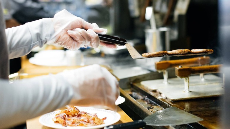 A Waffle House employee manning a grill