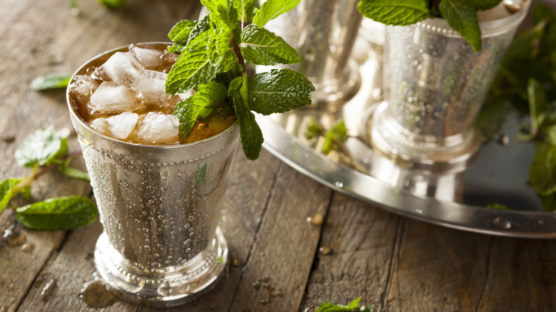 Mint juleps in silver cans with sprigs of mint
