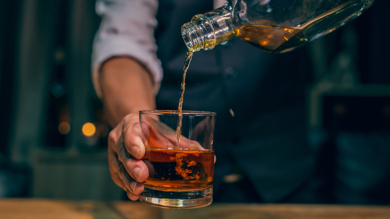 Barman pouring Scotch neat