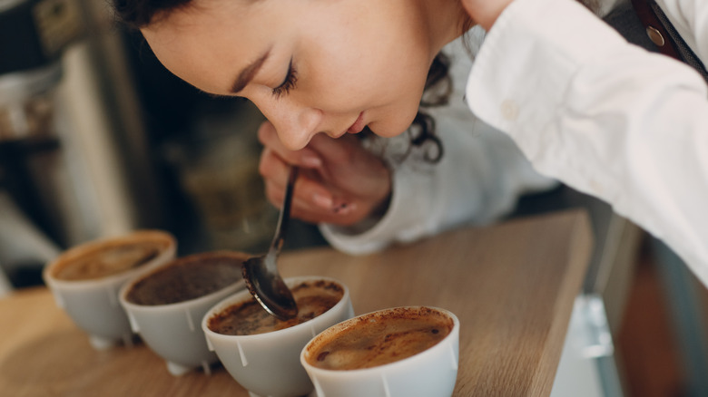 Lady smelling different types of coffee