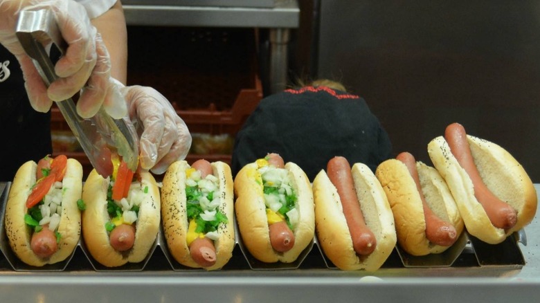 Steamed buns and hot dogs being assembled