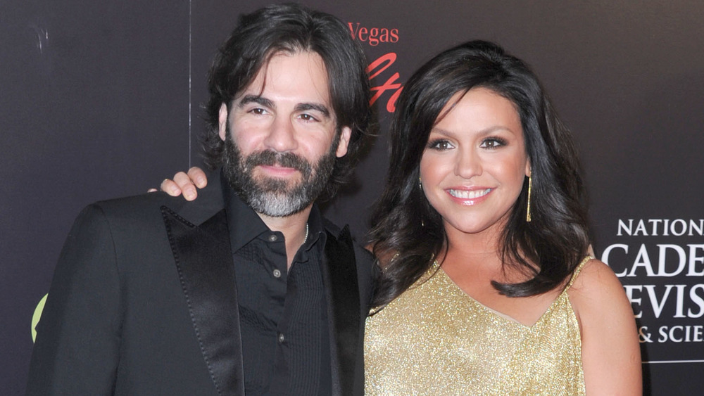 Rachael Ray in a gold dress with her husband