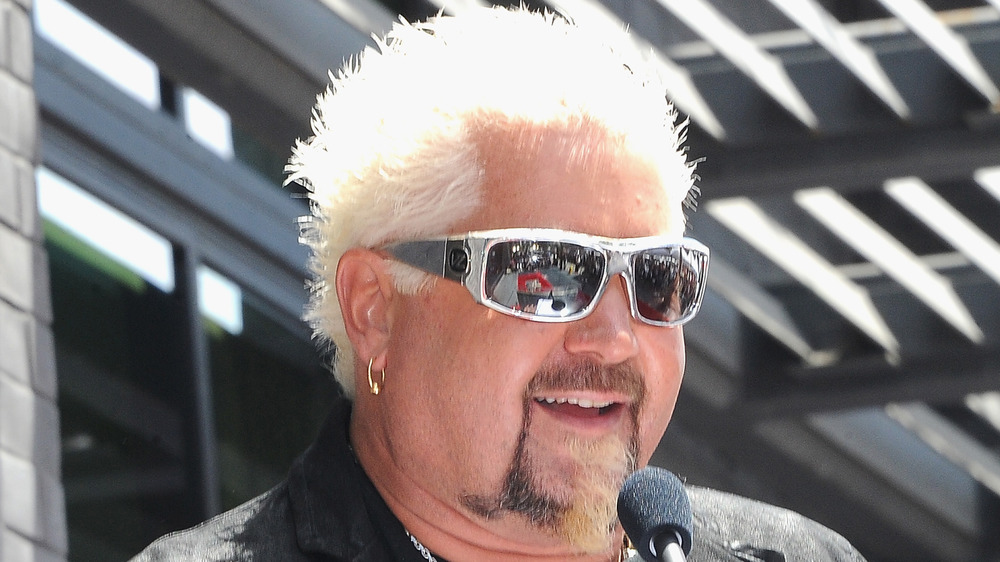 Guy Fieri in white rimmed sunglasses