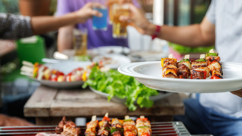 Person holding plate at summer barbecue