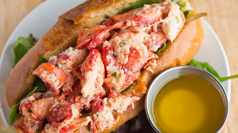 A lobster roll with butter on the side