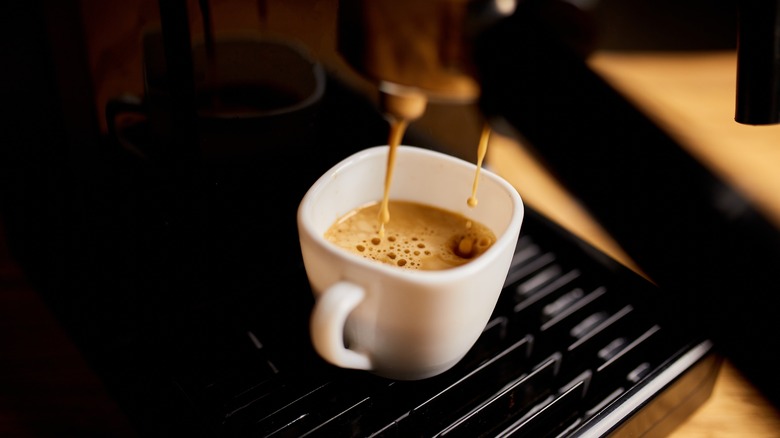 Espresso extracting into cup