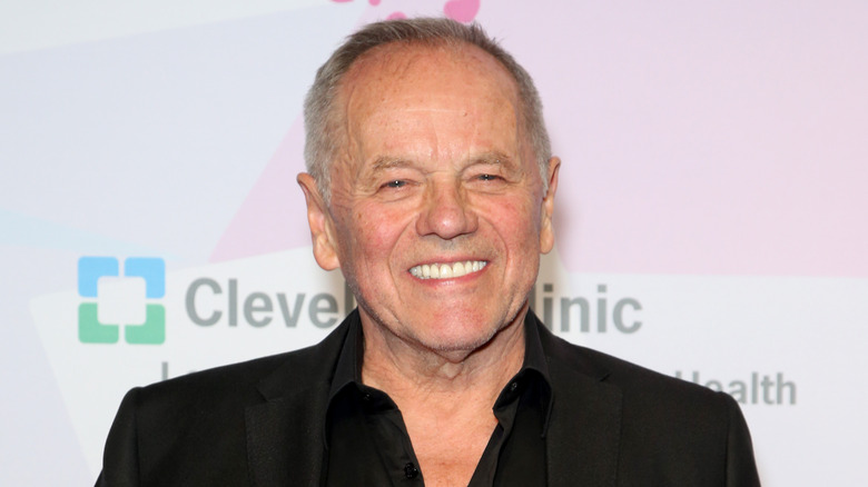 Wolfgang Puck smiling in black jacket