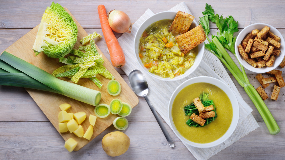 Savory cabbage soup in white bowls 