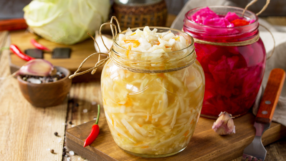 red and green sauerkraut in jars
