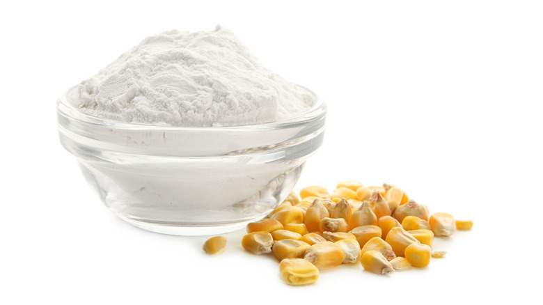Cornstarch in a bowl with corn kernels