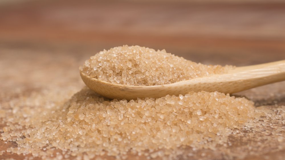 Demerara sugar on a wooden spoon