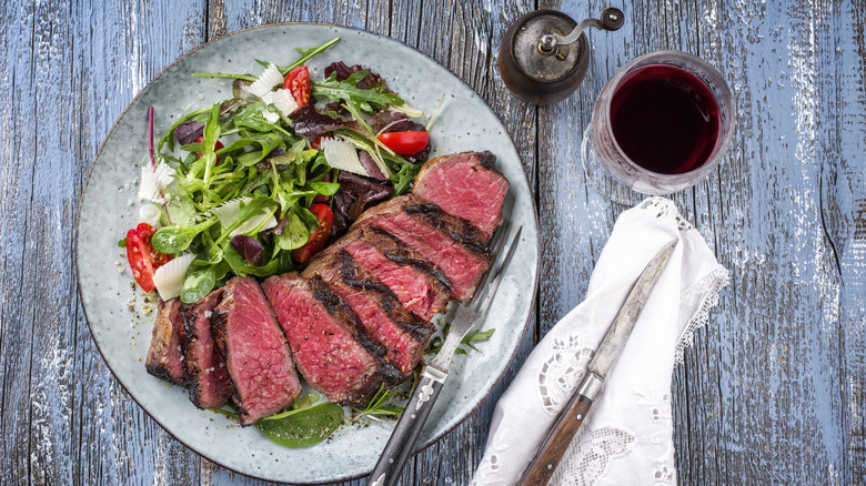 Prime rib on a plate with a salad