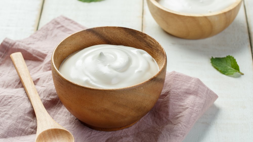 bowl of sour cream with wooden spoon