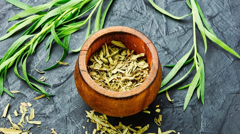 Dried tarragon leaves in a bowl