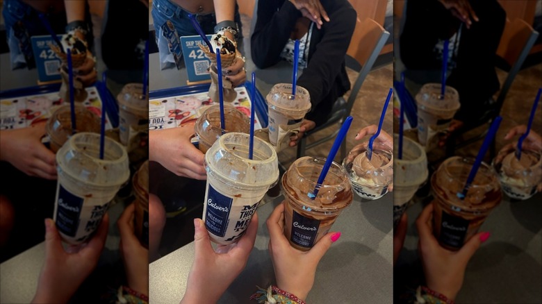 several people holding plastic Culver's cups with frozen custard