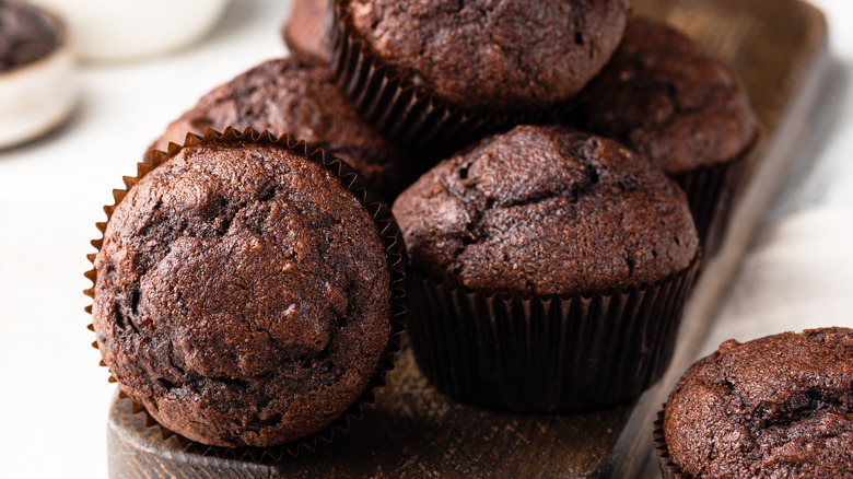 chocolate muffins on wood board