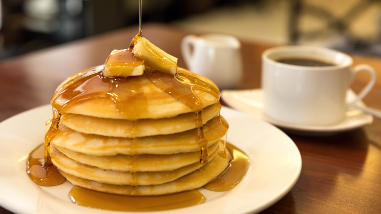 plate of restaurant pancakes with butter and syrup