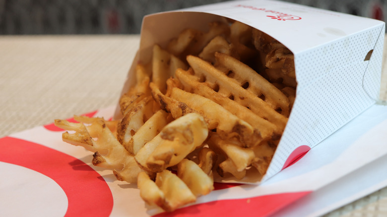 Carton of Chick-fil-A waffle fries on table
