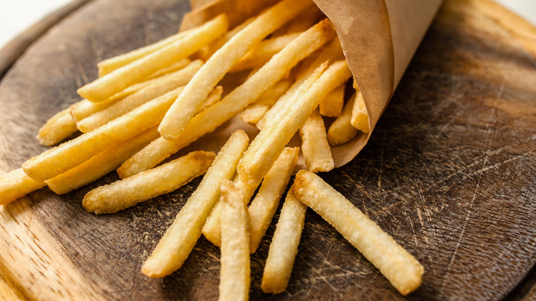Close-up of french fries in paper sleeve