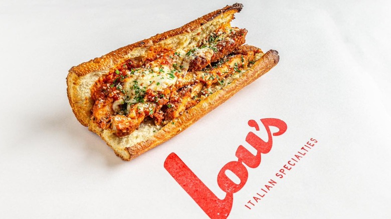The Lou's chicken Parmesan sandwich with the Lou's logo