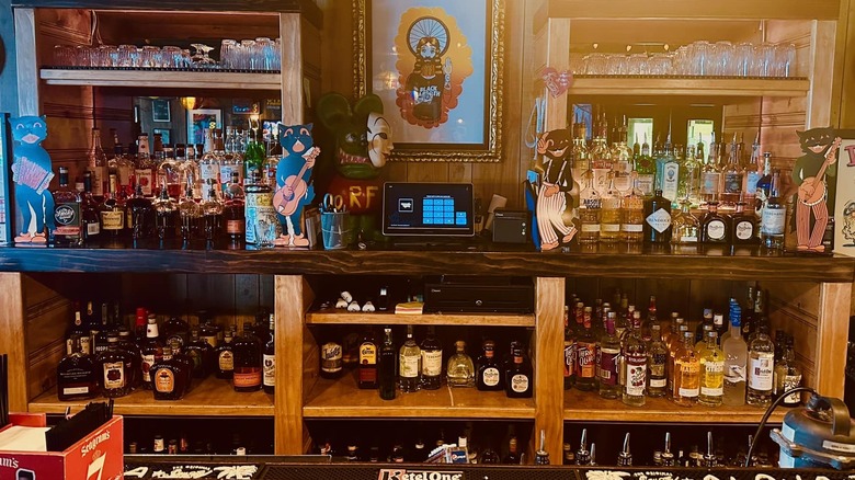 The bar at Maggie's Rumble Room with various liquors and decorations