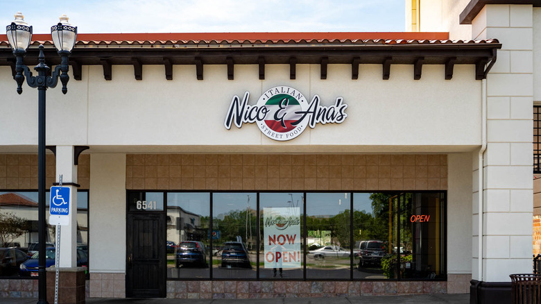 The exterior of Nico & Ana's with a Now Open sign