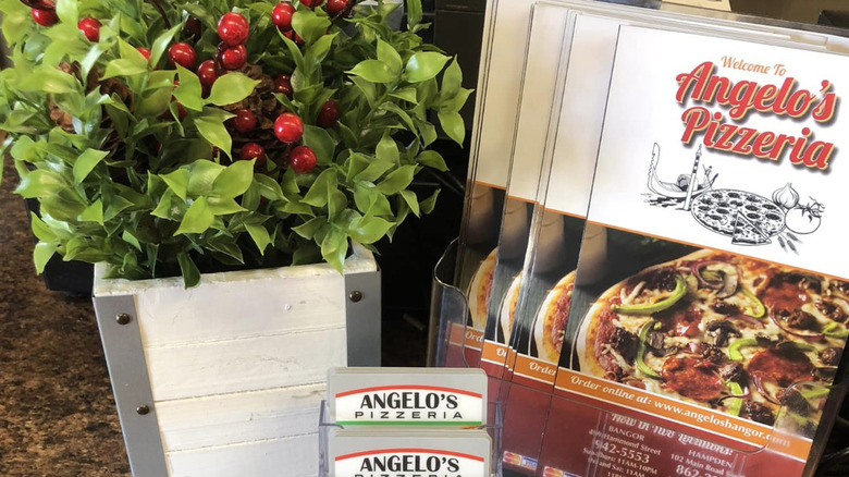 Angelo's Pizzeria fliers and business cards with a plant