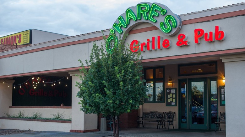 The front entrance to O'Hare's Grille & Pub with a neon sign