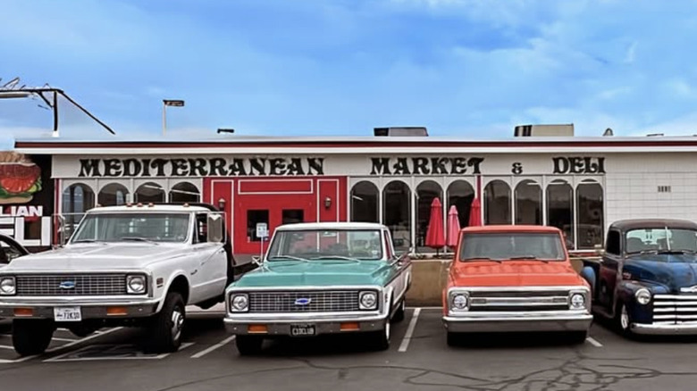 Antique cars parked in front of the Mediterranean Market & Deli in Salt Lake City