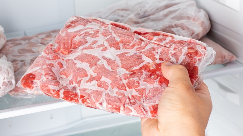 frozen meat being removed from freezer