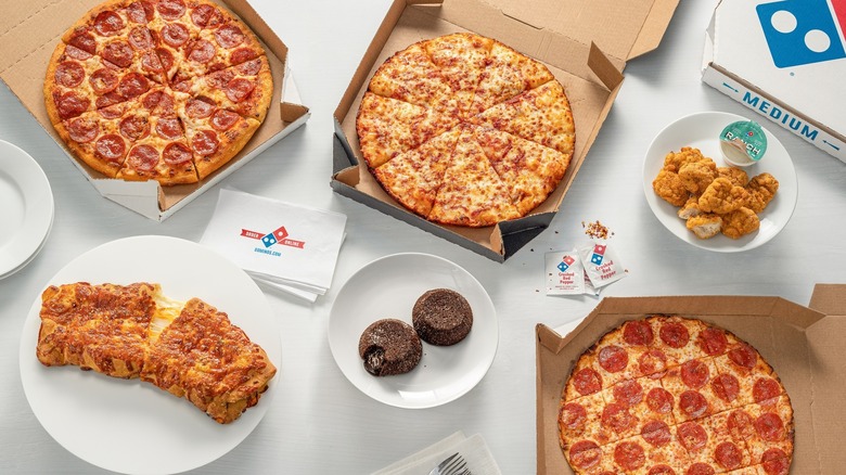 Domino's pizza and breadsticks spread out on a table