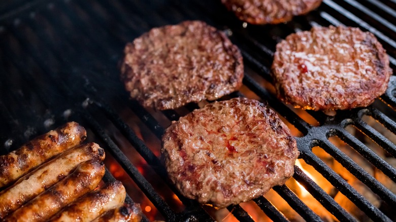 burgers and hot dogs on a grill