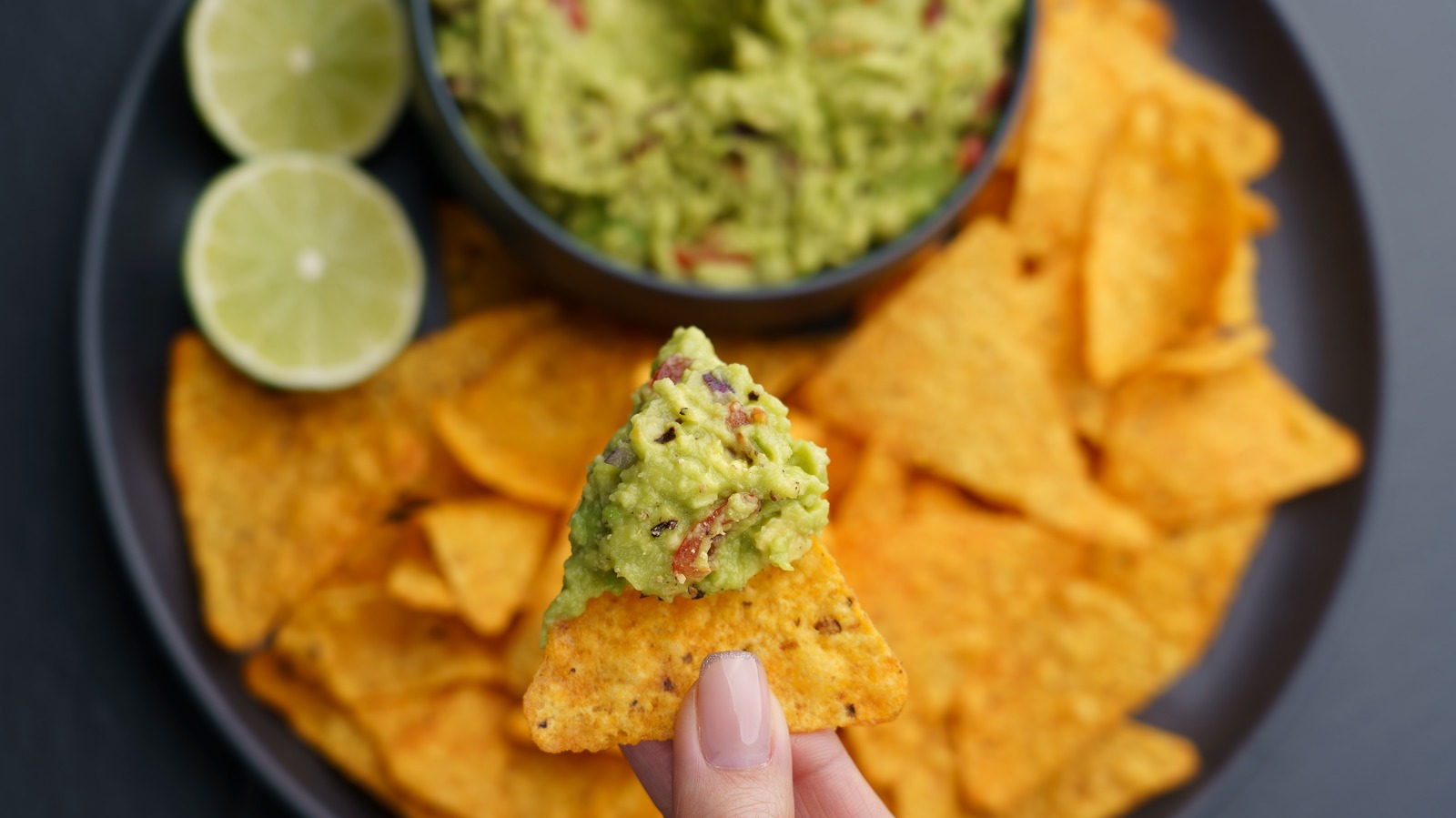 Here's Why Guacamole Always Costs Extra In Restaurants