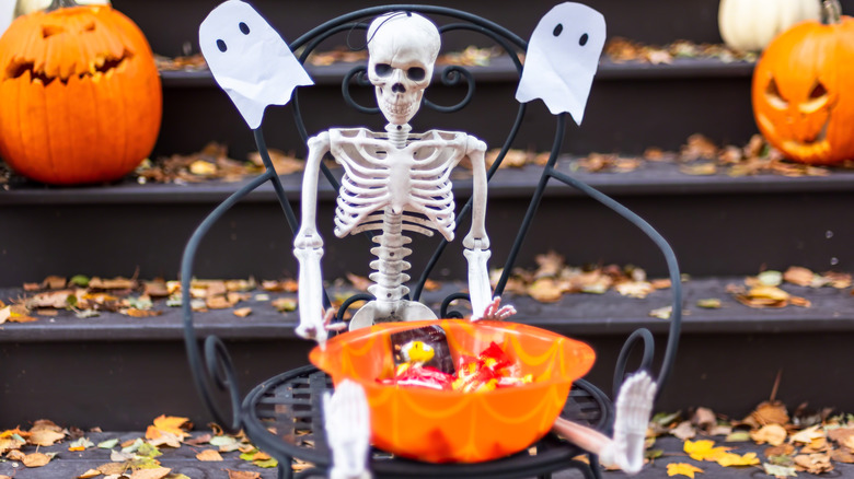 Skeleton with candy for trick or treaters