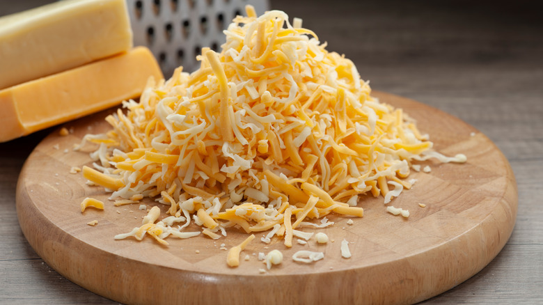 shredded cheese on cutting board