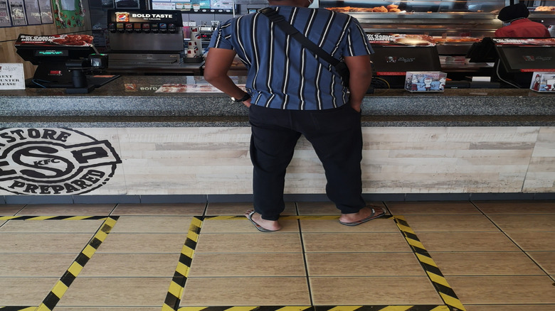 man waiting at KFC counter