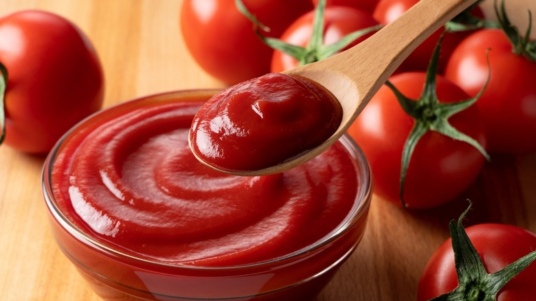 Tomato ketchup on a wooden spoon