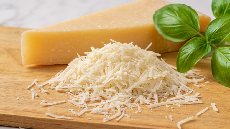 Shredded cheese on wooden board