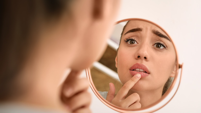 Woman looking at swollen lips