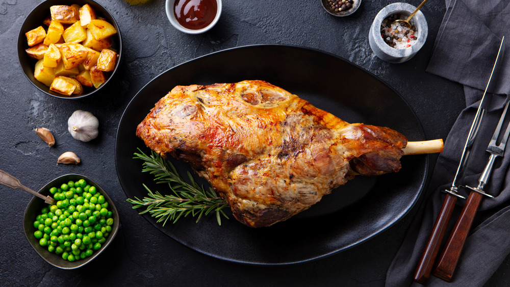 Roasted leg of lamb on a black plate