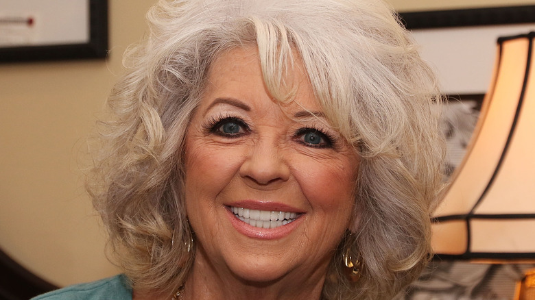 Paula Deen smiling in teal top