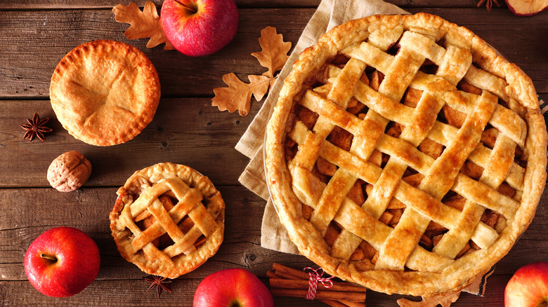 apple pies with lattice crust on wood background