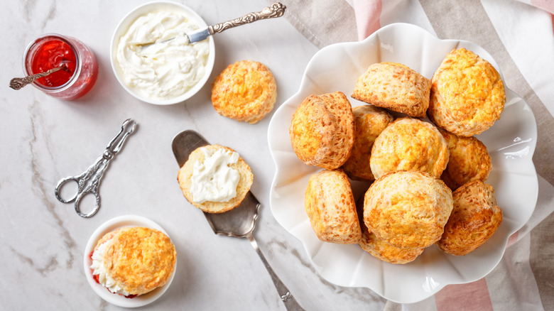 A bowl of scones with jam and clotted cream