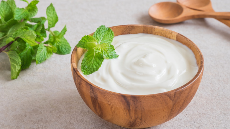 Plain yogurt in a wooden bowl 