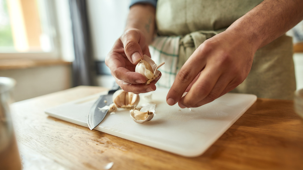 Person chopping garlic