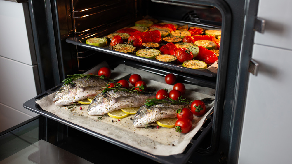 Roasting vegetables and fish in oven