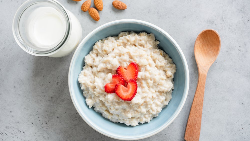 oatmeal in a blue bowl with strawberries on top