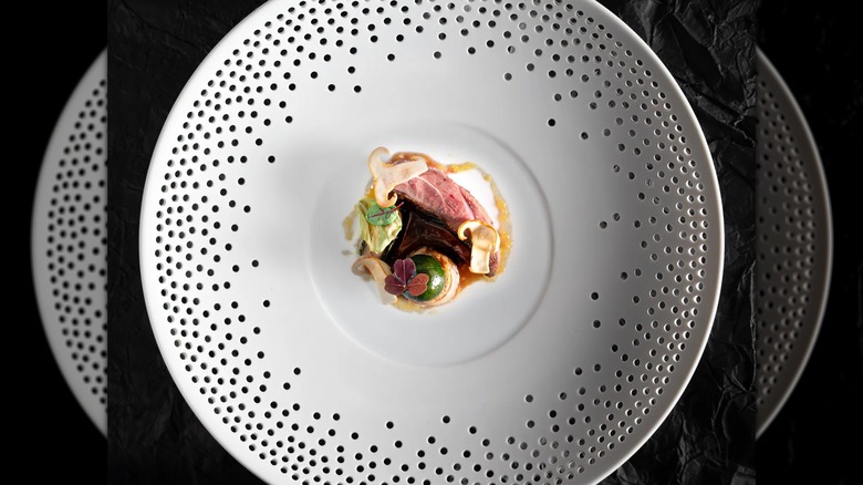 California squab dish from Brooklyn fare on a white dotted plate