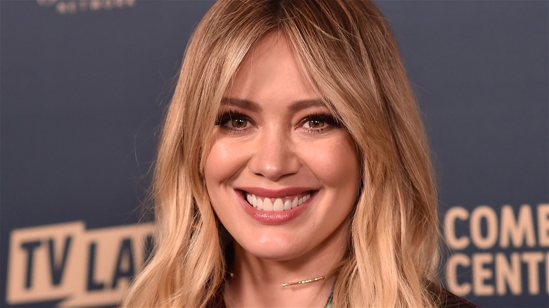 Hilary Duff smiling at a red carpet event