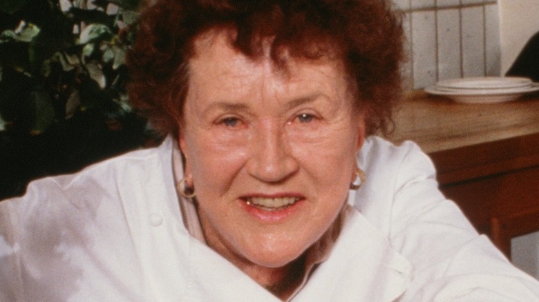 Julia Child  in white chef's coat smiling